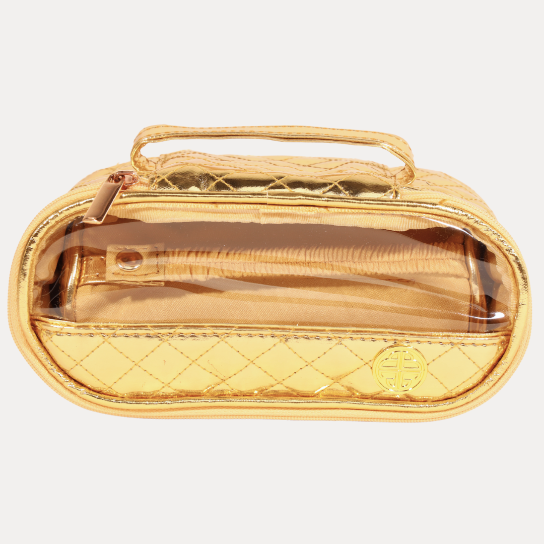 Gold quilted handbag with clear front panel on a light beige background
