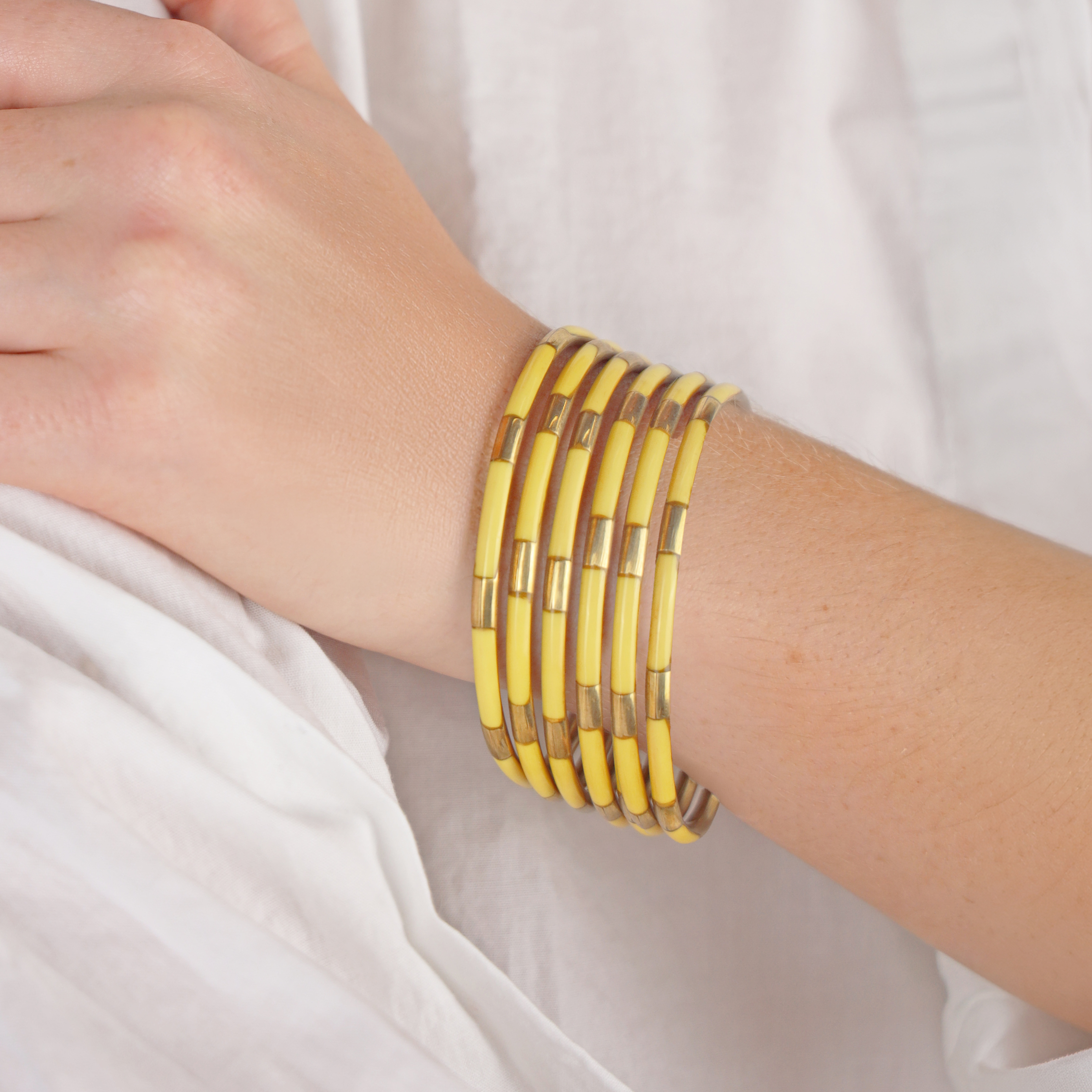 a person wearing yellow bracelets